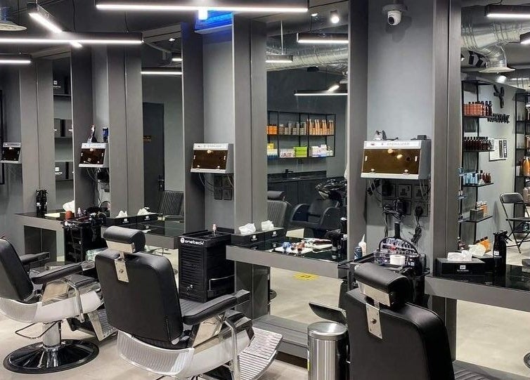Modern salon interior at AlYasmin 30 Degrees, Riyadh, Saudi Arabia, SA featuring sleek chairs and mirrors.