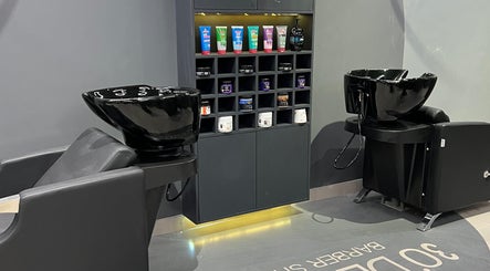 Modern shampoo station at 30Degrees Qirawan in Riyadh, Riyadh Province, SA with stylish black fixtures.