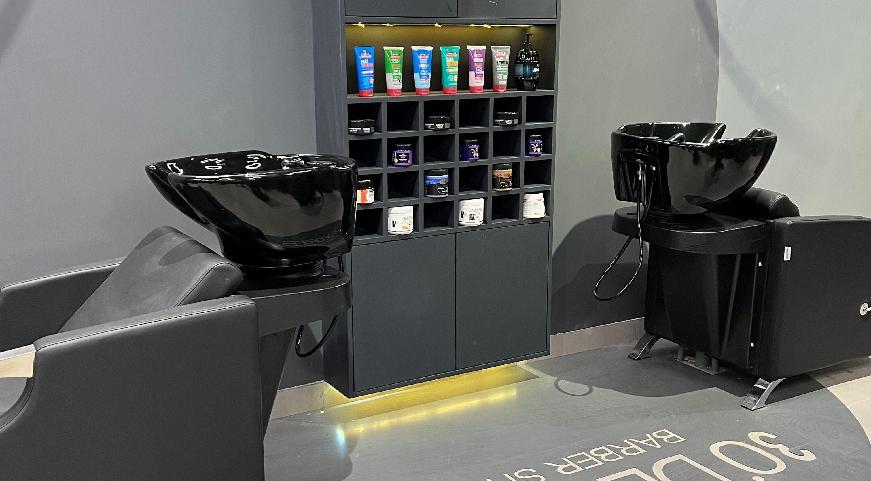 Modern shampoo station at 30Degrees Qirawan in Riyadh, Riyadh Province, SA with stylish black fixtures.