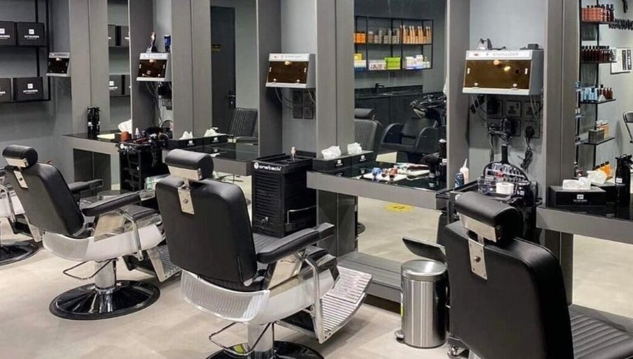 Modern salon interior at AL Falah 30 Degrees in Riyadh, Riyadh Province, SA, featuring sleek black chairs.
