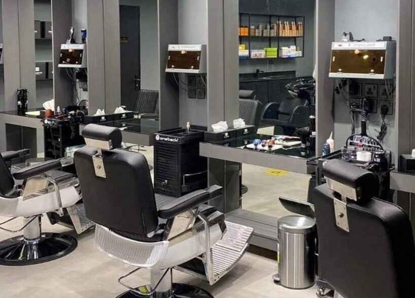 Modern salon interior at AL Falah 30 Degrees in Riyadh, Riyadh Province, SA, featuring sleek black chairs.