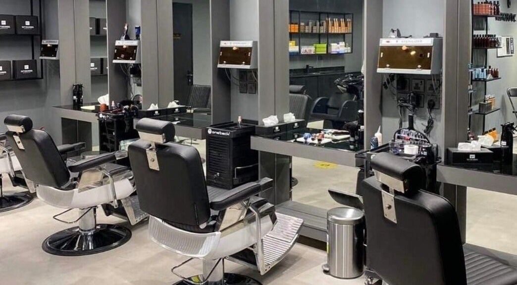 Modern salon interior at AL Falah 30 Degrees in Riyadh, Riyadh Province, SA, featuring sleek black chairs.