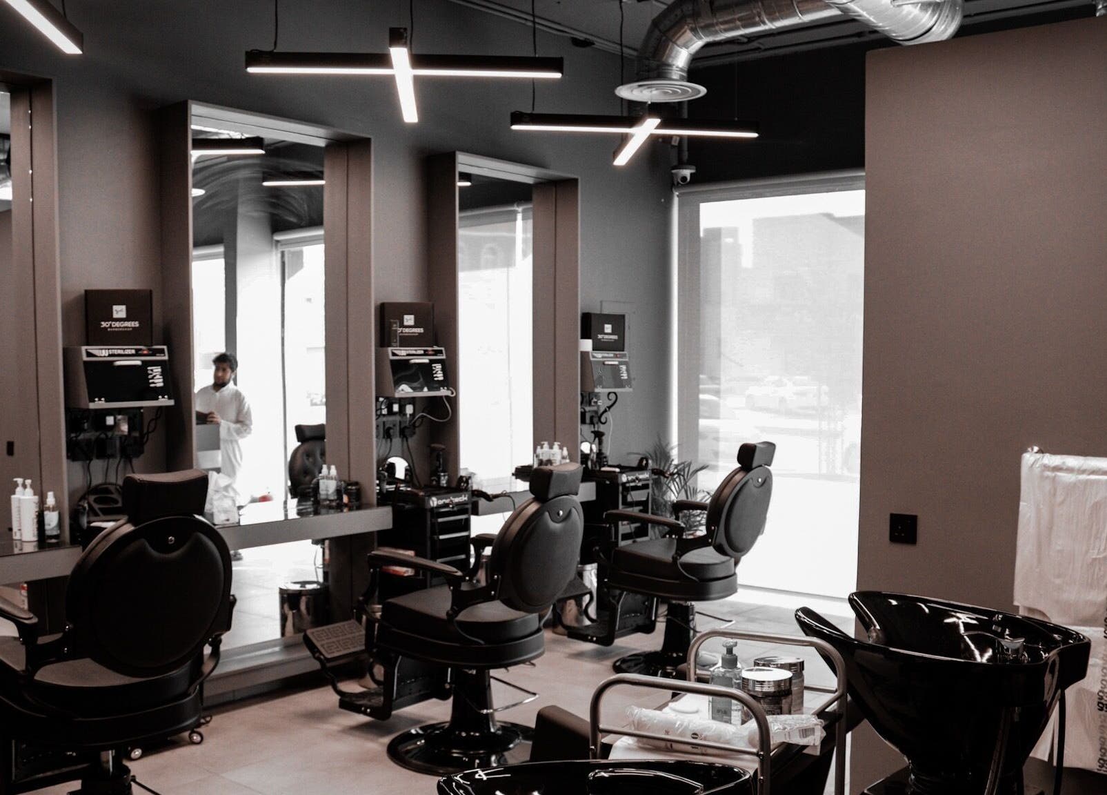 Modern salon interior at AL Falah 30 Degrees, Riyadh, Riyadh Province, SA with sleek chairs and large mirrors.