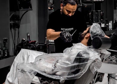 Professional stylist at AL Falah 30 Degrees barber shop in Riyadh, Riyadh Province, SA, offering top-notch grooming.