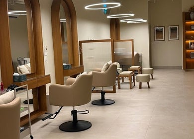 Chic interior of NAY SALON in Riyadh, featuring elegant chairs and mirrors for a relaxing beauty experience.