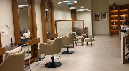Chic interior of NAY SALON in Riyadh, featuring elegant chairs and mirrors for a relaxing beauty experience.