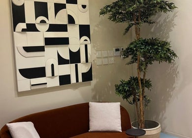 Stylish lounge area at NAY SALON, Riyadh, Riyadh Province, SA with modern art and lush greenery.