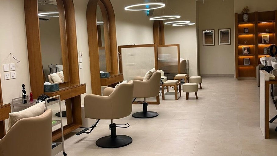 Sleek salon interior at NAY SALON, Riyadh, Riyadh Province, SA with modern styling chairs and warm lighting.