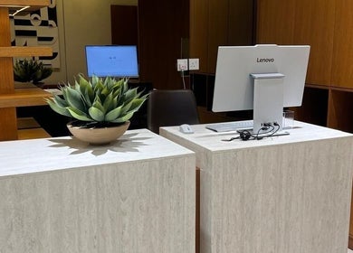 Modern reception desk at NAY SALON, Riyadh, Riyadh Province, SA with decorative plant and computer setup.