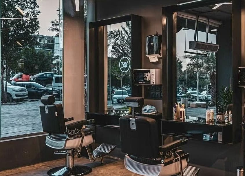 Modern salon interior at Dhahrat Laban 30Degrees, Riyadh, Riyadh Province, SA featuring stylish barber chairs.