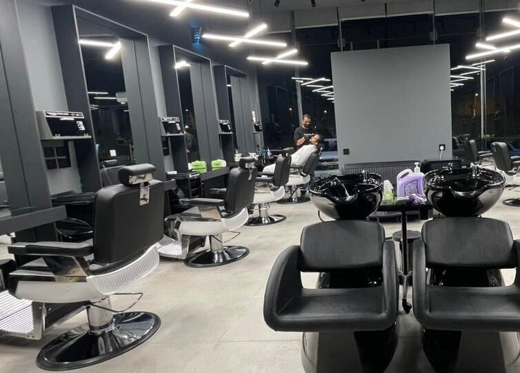 Elegant salon interior at Qurtubah 30 Degrees, Riyadh, Riyadh Province, SA featuring sleek black styling chairs.