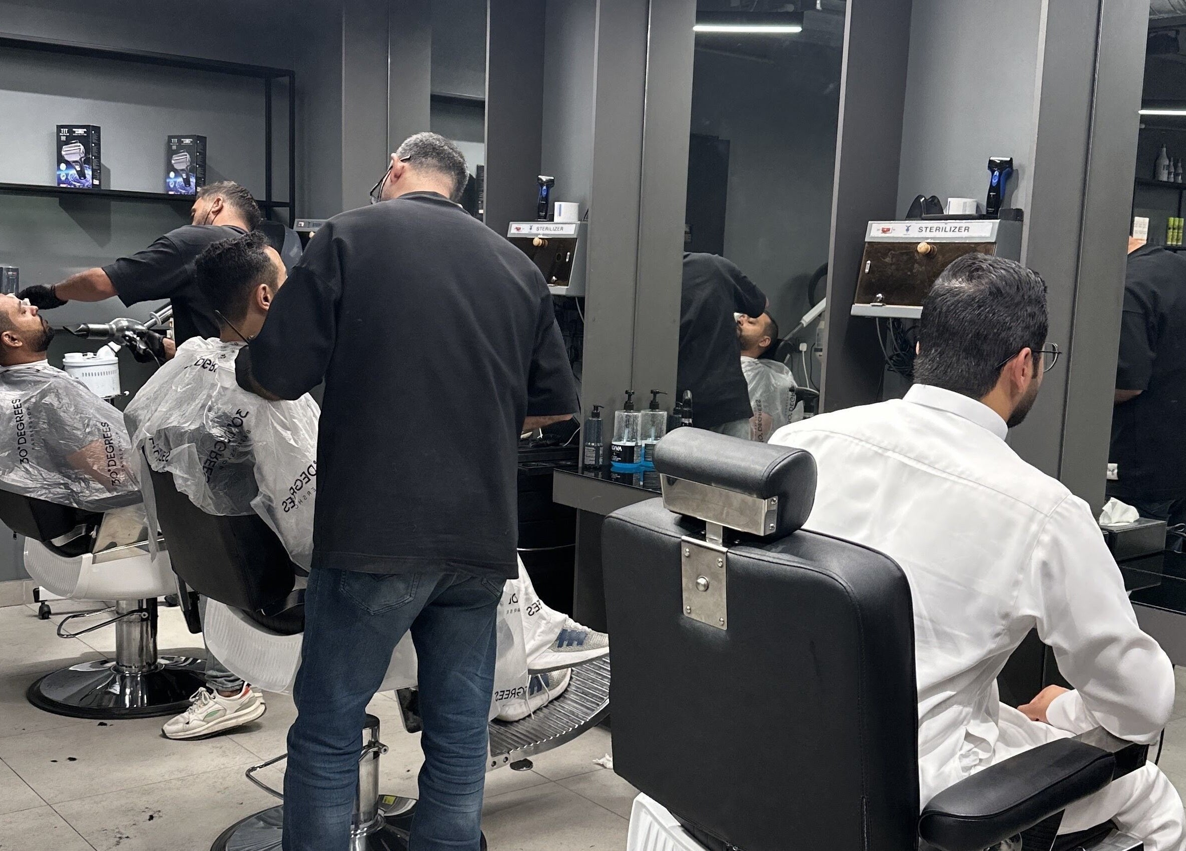 Barbers providing grooming services at Al Izdihar 30 Degrees in Riyadh, Riyadh Province, SA.