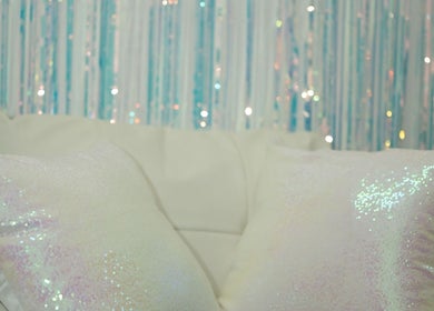 Luxurious sequin pillows on a cozy couch at 109 W 38th St, Fl 3, New York, NY 10018, New York, New York, US.