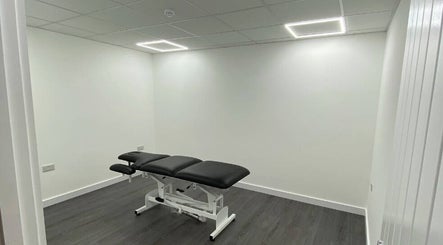 Spacious treatment room at PJ Sports Rehab in Bideford, England, GB with a professional therapy table.