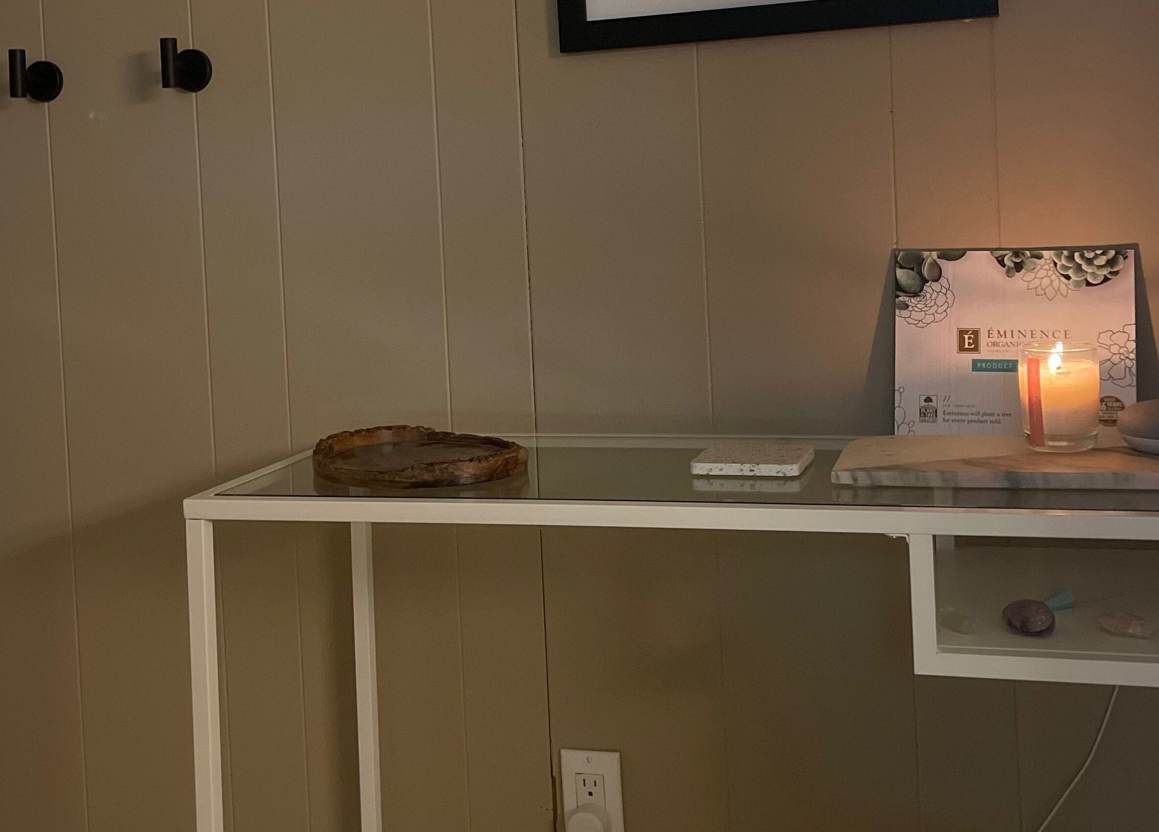 Tranquil spa setting at Sarah Vlasblom in Ottawa, Ontario, CA with a lit candle and elegant decor.