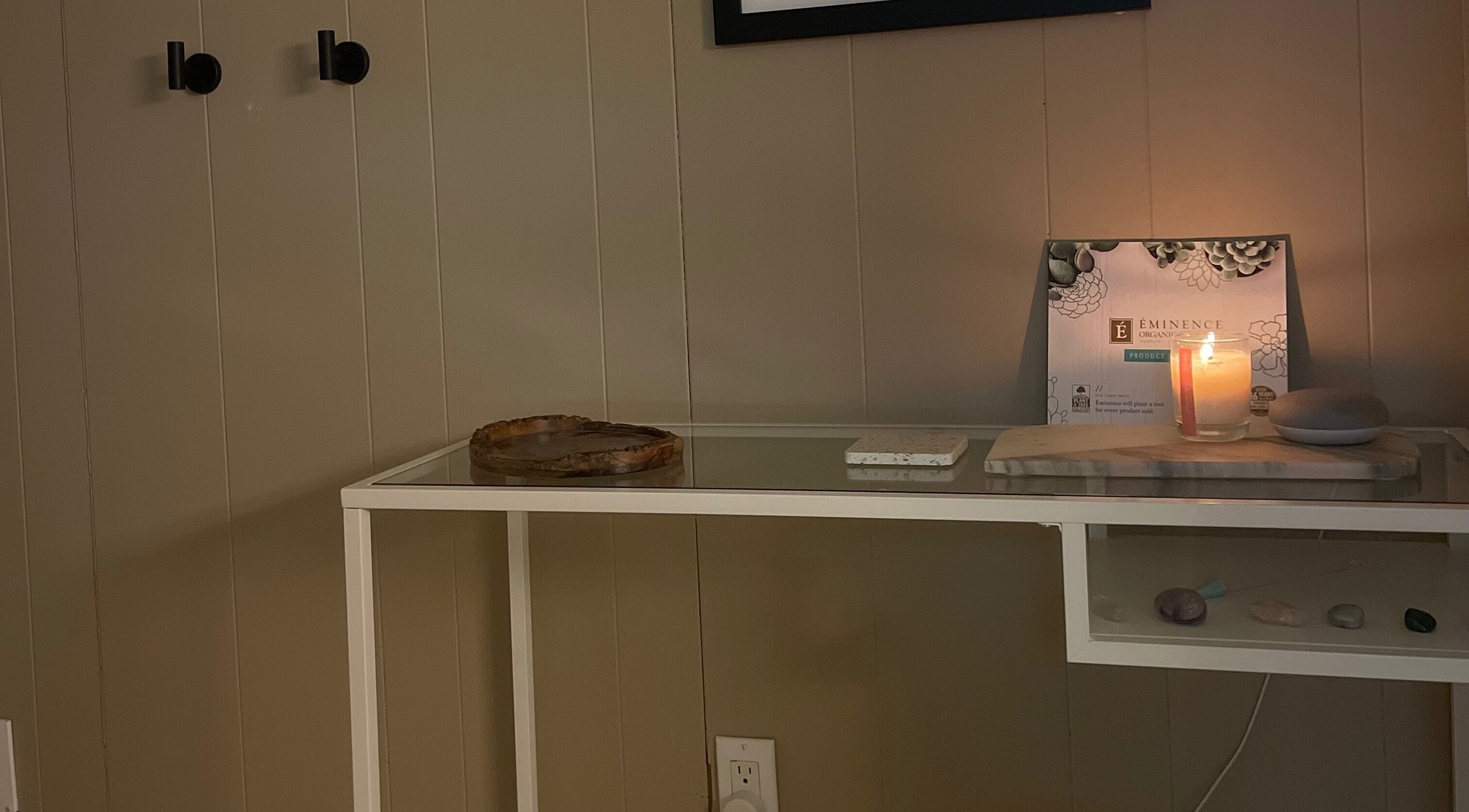 Tranquil spa setting at Sarah Vlasblom in Ottawa, Ontario, CA with a lit candle and elegant decor.