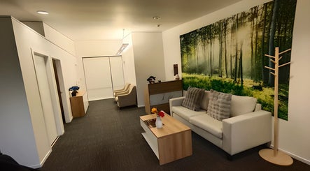 Relaxing lounge at Darawan Thai Massage, Auckland, Auckland, NZ, featuring cozy seating and nature-themed decor.