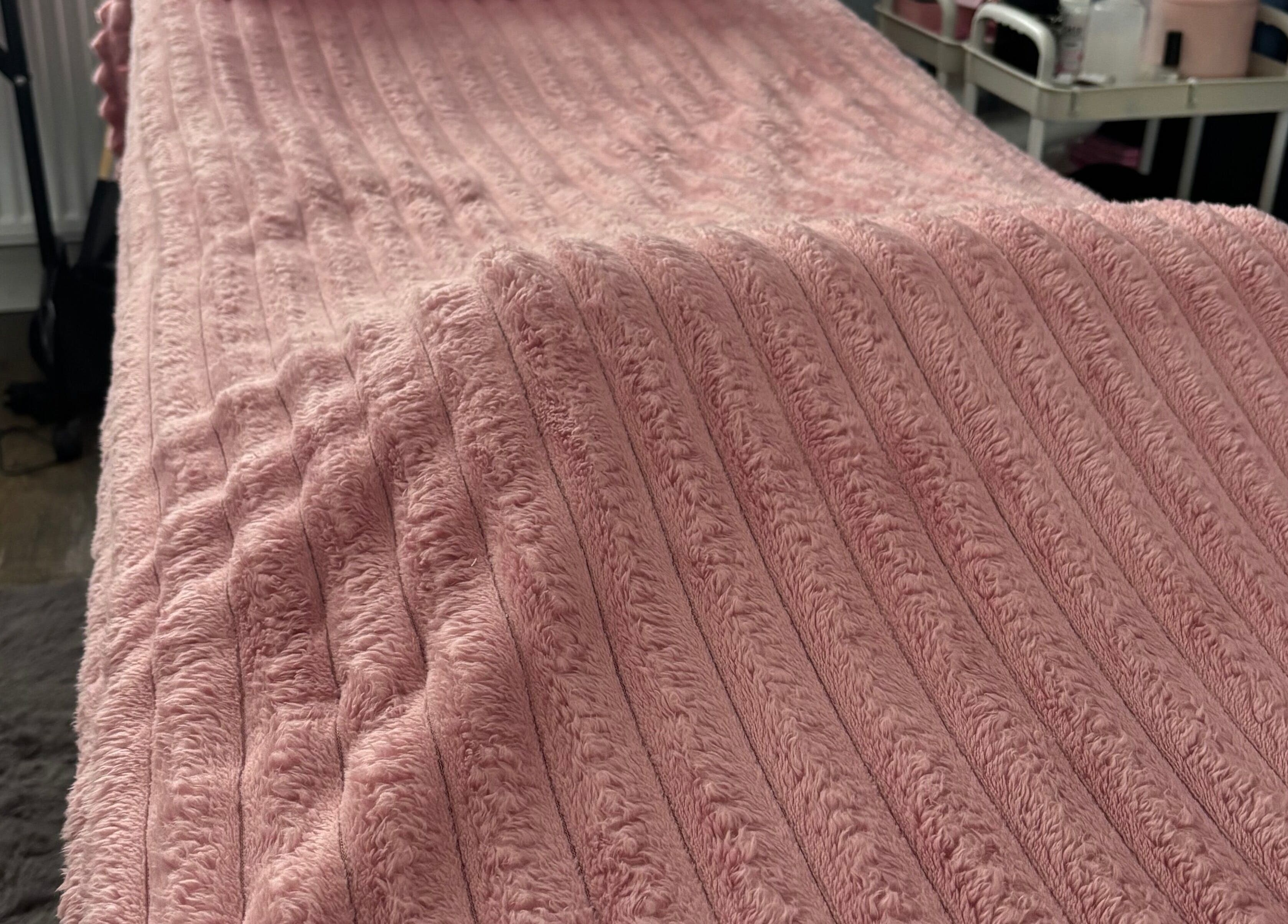 Soft pink treatment bed at Torvelle Beauty, Churchdown, England, GB, showcasing comfort and elegance.