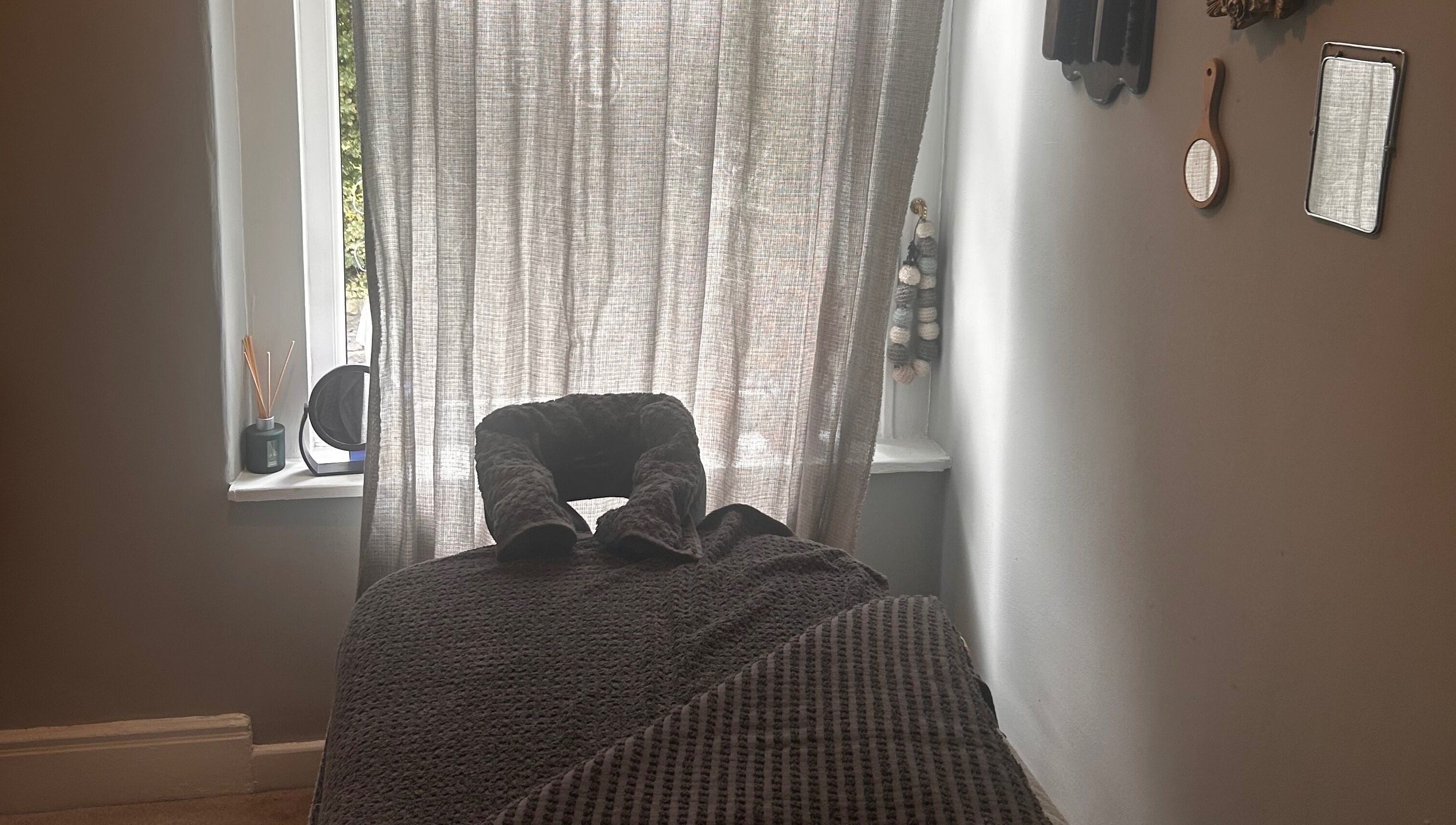 Relaxing massage room at Bethesda Beauty in Rawdon, England, GB featuring a comfortable treatment bed.