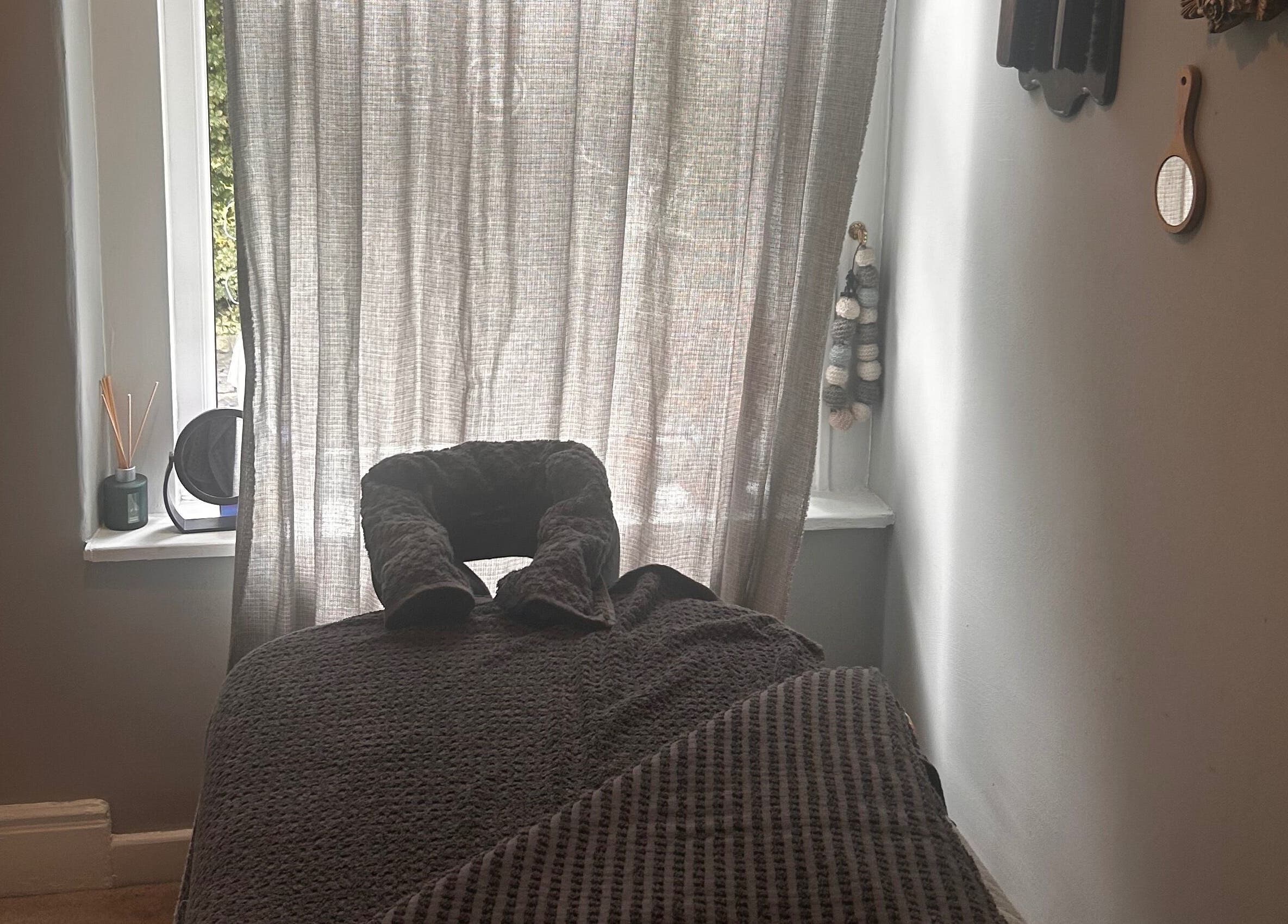 Relaxing massage room at Bethesda Beauty in Rawdon, England, GB featuring a comfortable treatment bed.