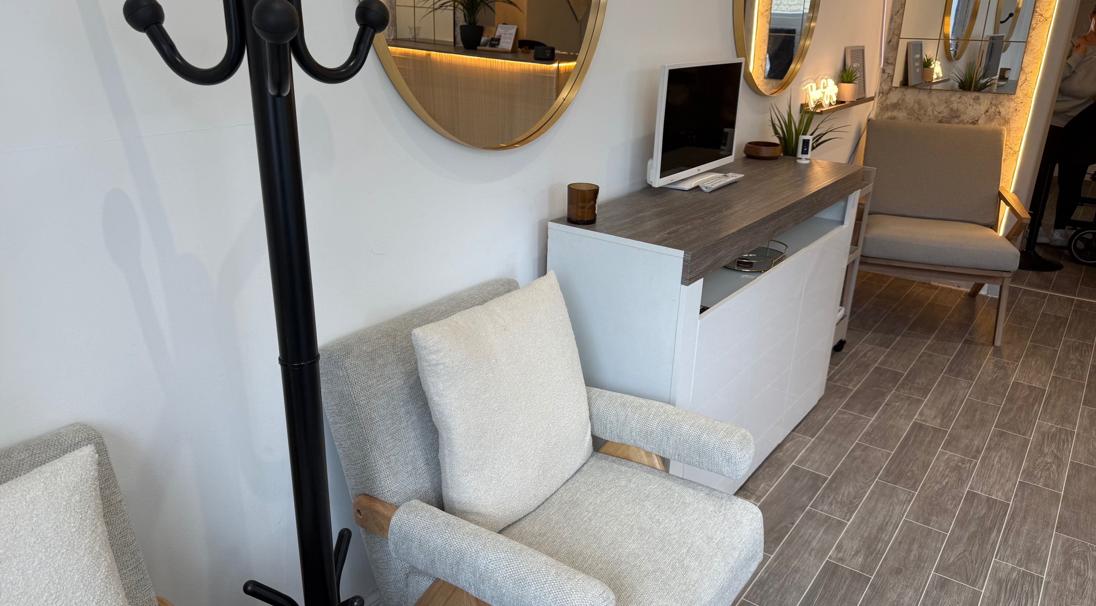 Stylish seating area at Lashedbycourtxx, Stalybridge, England, GB, featuring modern decor and cozy chairs.