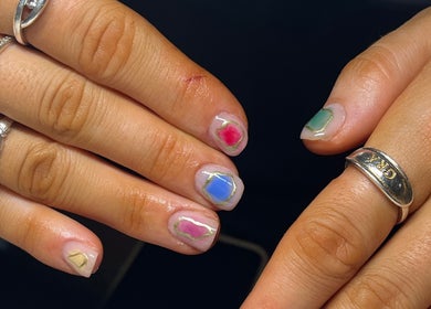 Colorful geometric nail art at EM Nails, Belfast, Northern Ireland, GB, with unique jewelry.