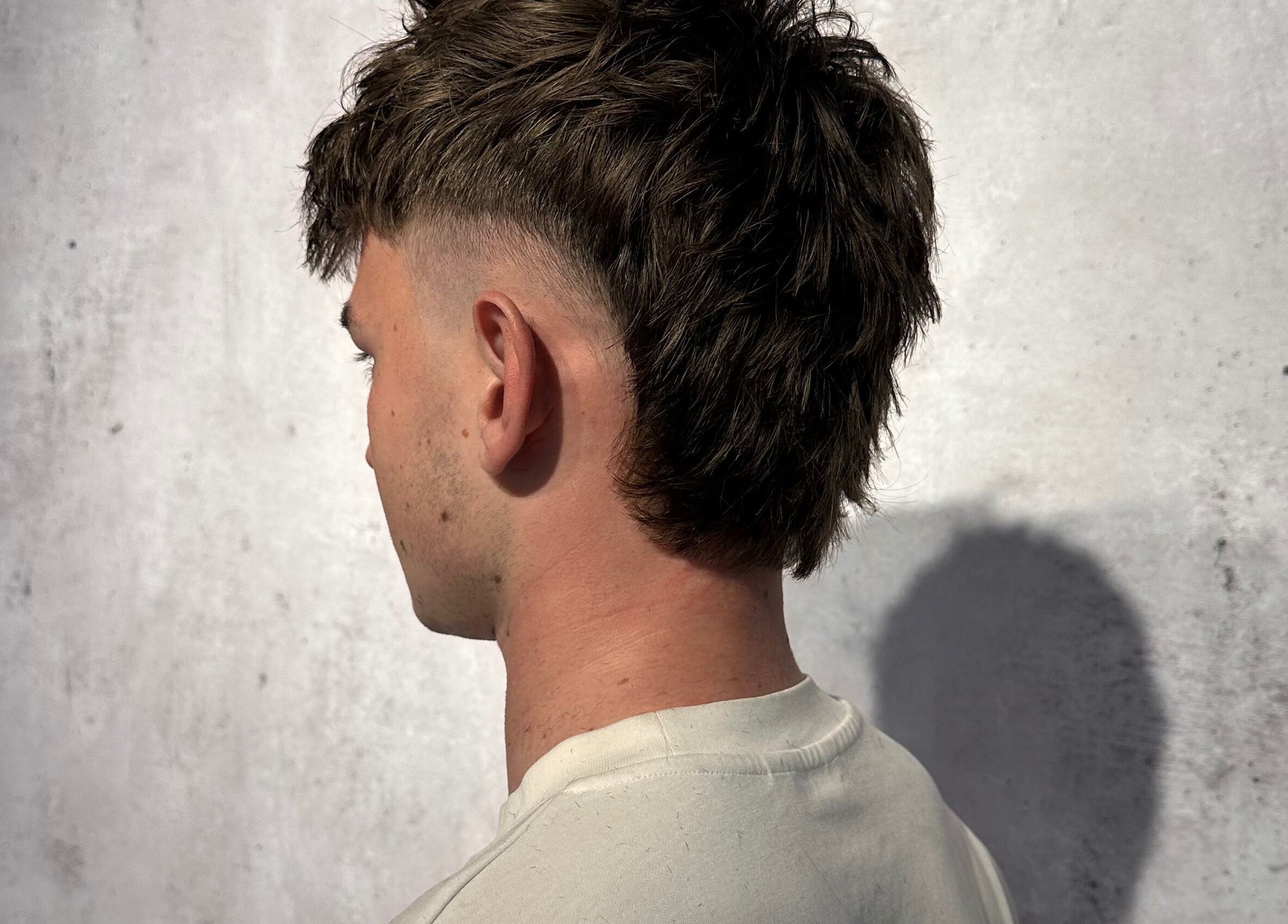 Trendy mullet hairstyle at Noble Blendz, Melbourne, Victoria, AU. Clean fade with textured length.
