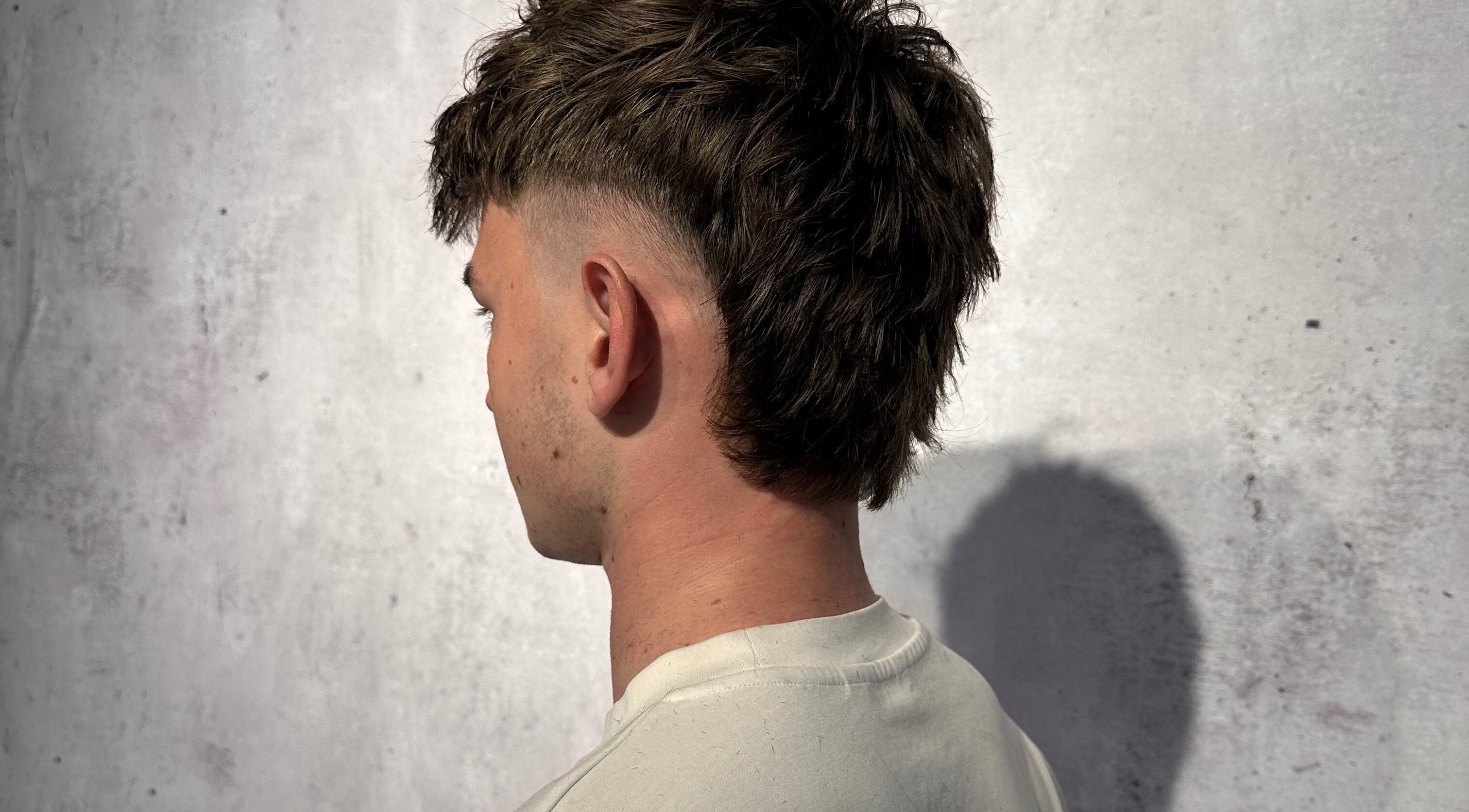 Trendy mullet hairstyle at Noble Blendz, Melbourne, Victoria, AU. Clean fade with textured length.