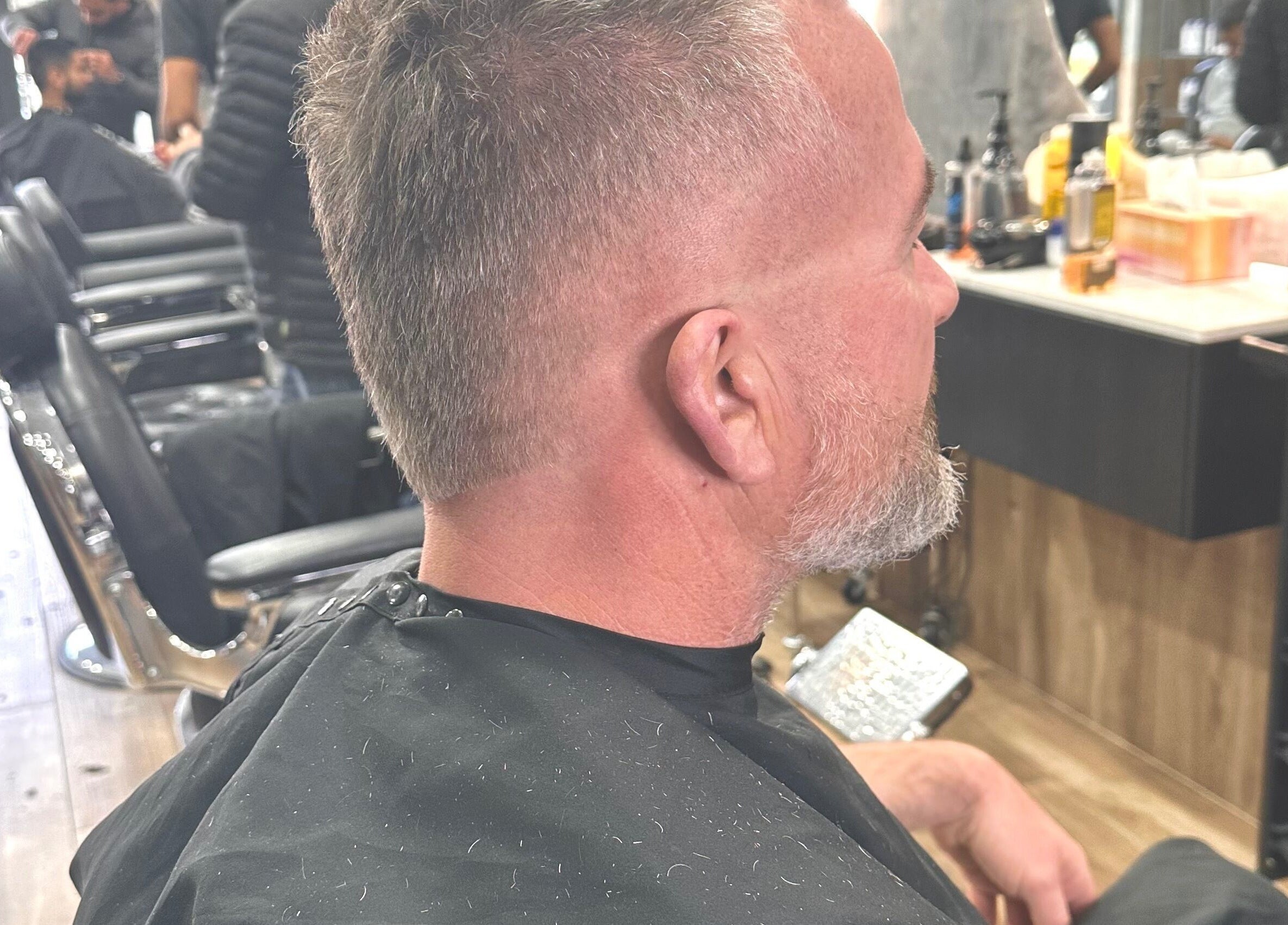 Client experiencing a stylish haircut at Noble Blendz barber in Melbourne, Victoria, AU.