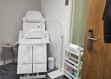 RC BeautyLab treatment room in Manchester, England, GB featuring a modern white therapy chair and equipment.