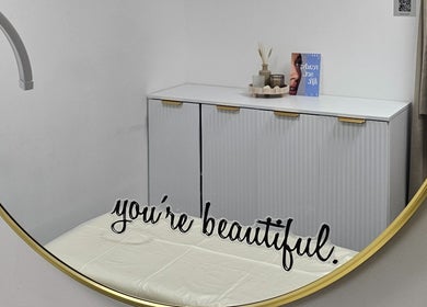 Elegant mirror at RC BeautyLab, Manchester, England, GB, reflecting a modern cabinet and decor.