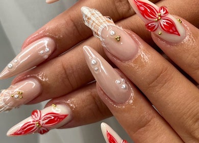 Intricate nail designs at Nails Džo, Novi Sad, Vojvodina, RS showcase red floral and bead accents.