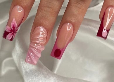 Elegant pink and red floral nail art at Nails Džo, Novi Sad, Vojvodina, RS on a satin background.