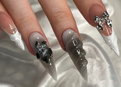 Stylish manicure at Nails Džo, Novi Sad, Vojvodina, RS showcasing unique nail art with black and white designs.
