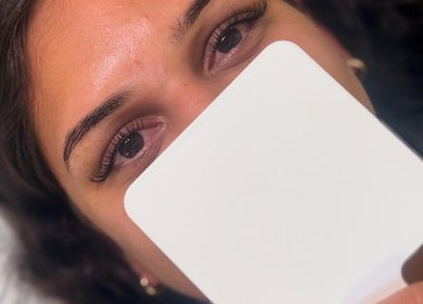 Close-up of a woman admiring her eyelash extensions at M&M BEAUTY, Kelso, Queensland, AU.