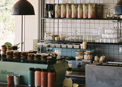 Warm, inviting interior of Aurenda Coffee Co at Kings Beach, Queensland, AU with coffee cups and decor.