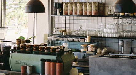Warm, inviting interior of Aurenda Coffee Co at Kings Beach, Queensland, AU with coffee cups and decor.