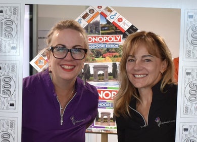 W Wellness Centre staff smiling with Monopoly frame at Bungendore, New South Wales, AU.