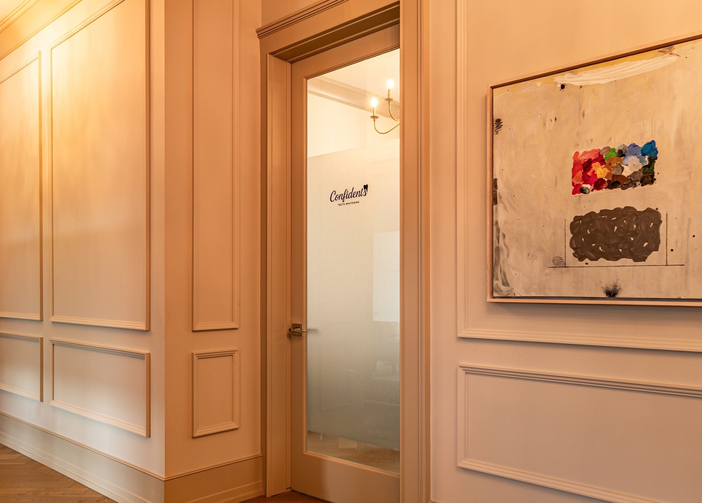 Chic entryway at Confidents Teeth Whitening, Calgary, Alberta, CA, with art and chandelier lighting.