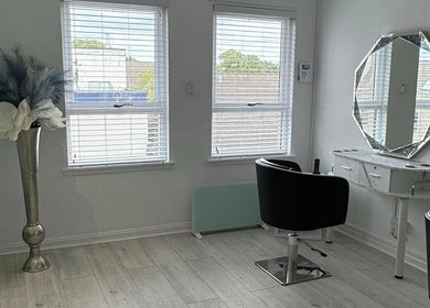 Elegant salon interior at More Than Skin By Diane, East Kilbride, Scotland, GB with modern decor and styling chair.