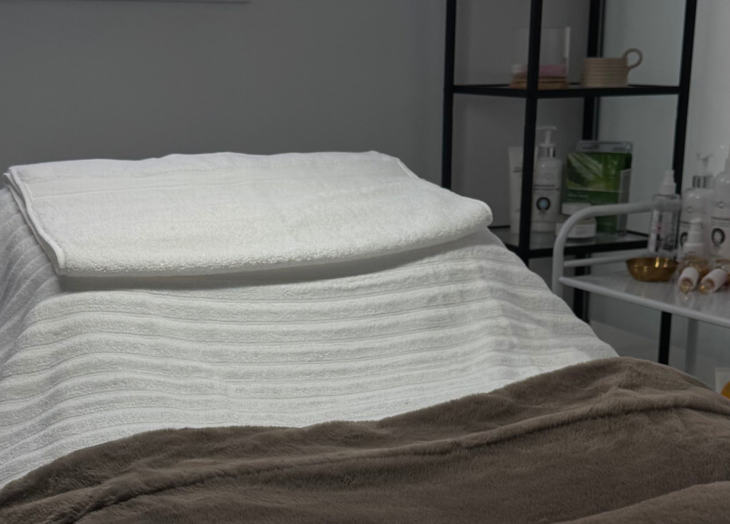 Treatment bed at More Than Skin By Diane, Hamilton, Scotland, GB, surrounded by soothing spa products.