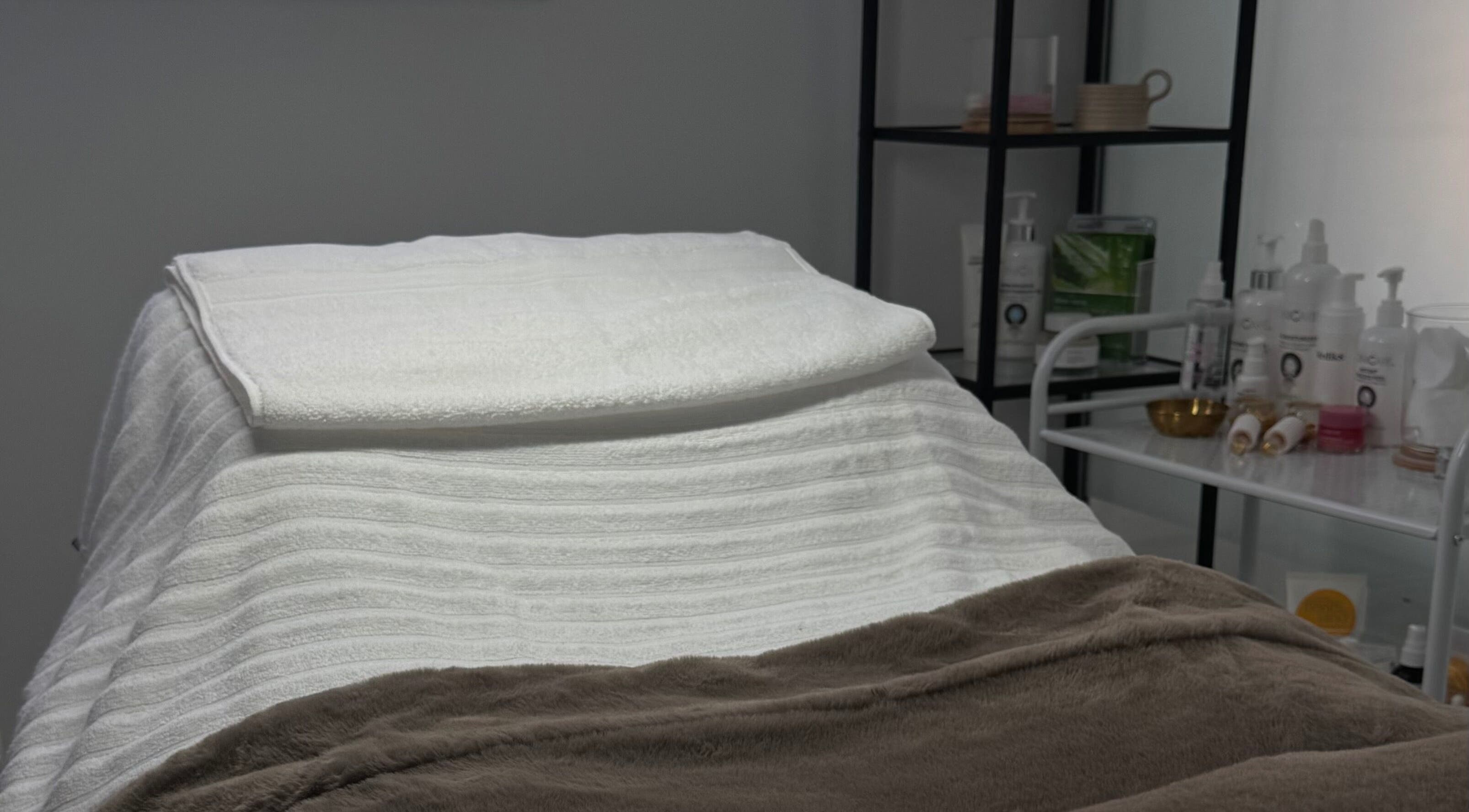 Treatment bed at More Than Skin By Diane, Hamilton, Scotland, GB, surrounded by soothing spa products.