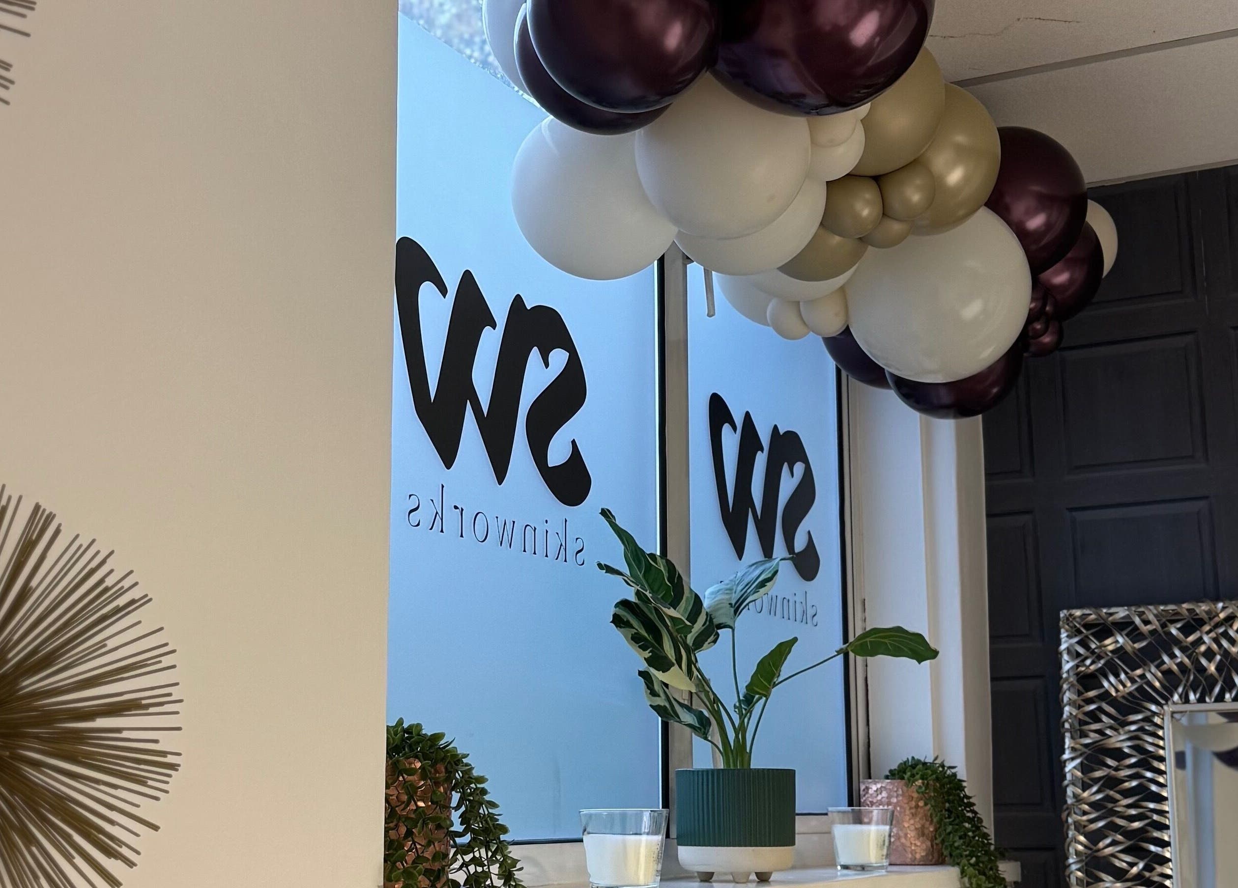 Elegant decor at More Than Skin By Diane, Hamilton, Scotland, GB with balloons and greenery.