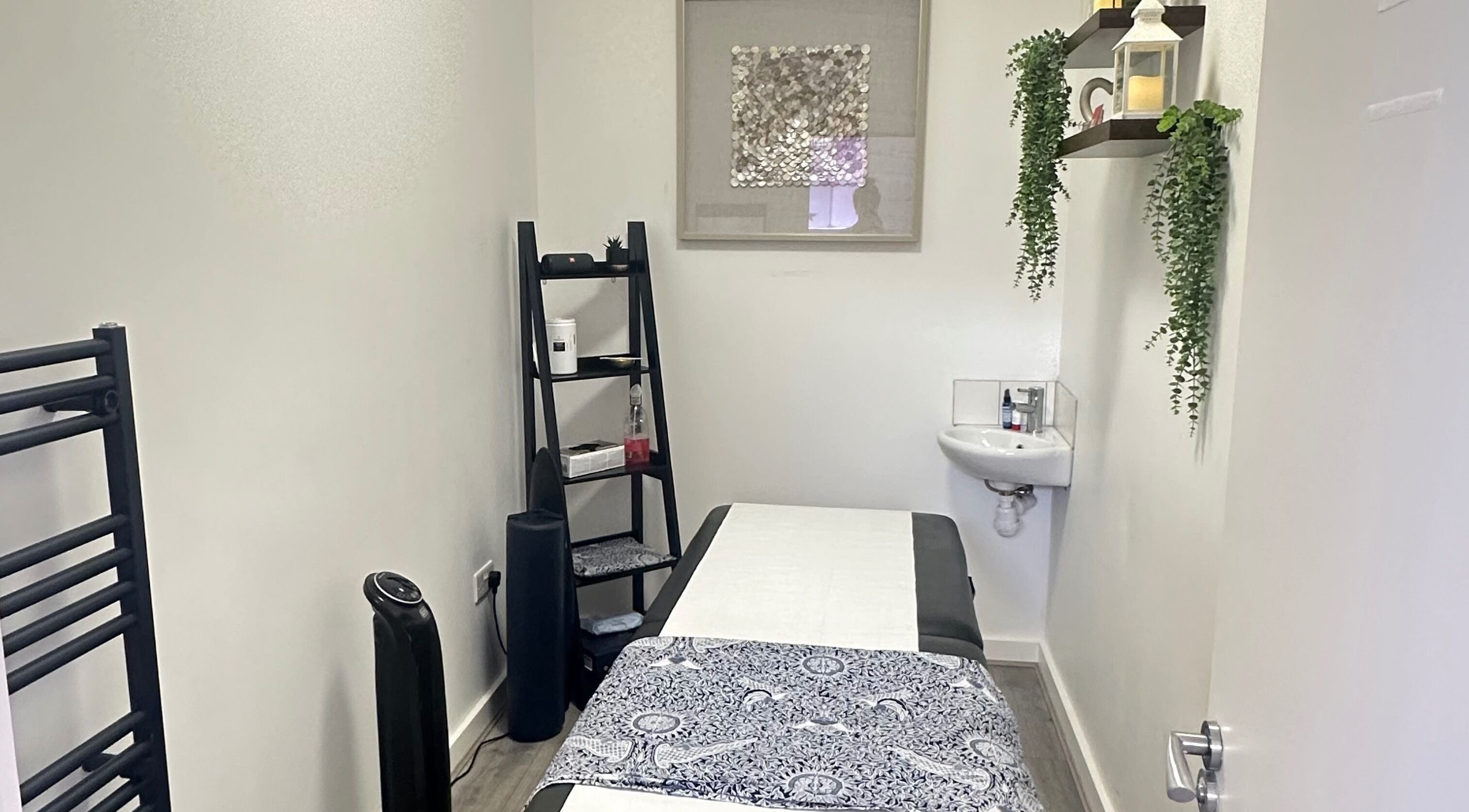 Calming massage room at RJ Sports Massage Therapy in Cheltenham, England, GB with a massage table and soothing decor.