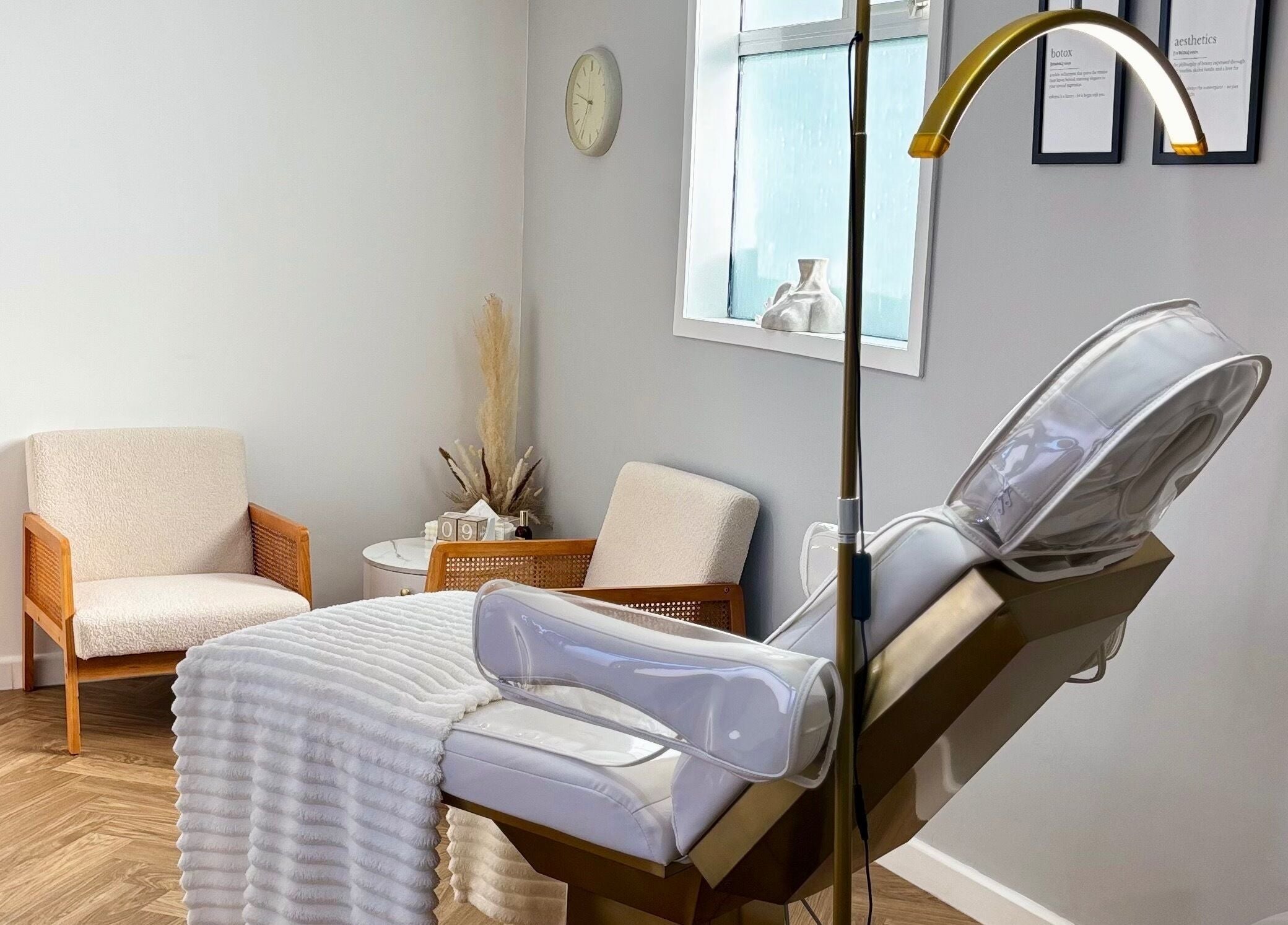 Relaxing spa room at House Of Hamilton Aesthetics, Hemel Hempstead, England, GB with comfy chairs and treatment bed.