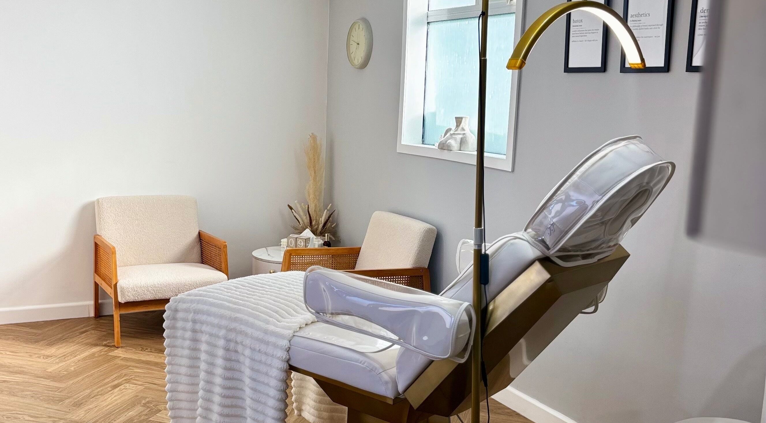 Relaxing spa room at House Of Hamilton Aesthetics, Hemel Hempstead, England, GB with comfy chairs and treatment bed.