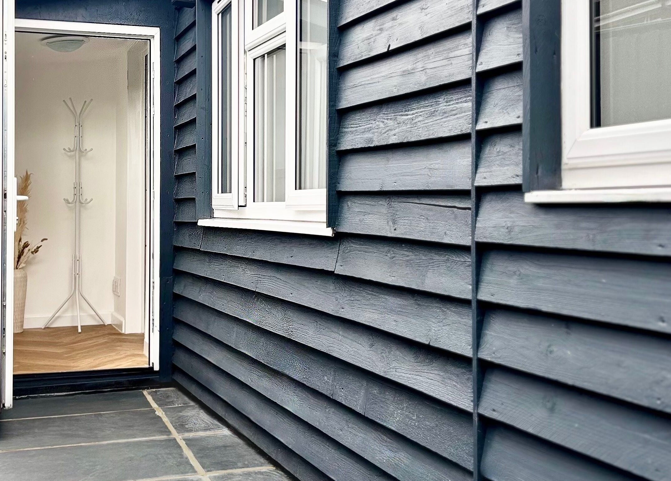 Entrance at House Of Hamilton Aesthetics, Hemel Hempstead, England, GB featuring sleek dark wooden exterior.