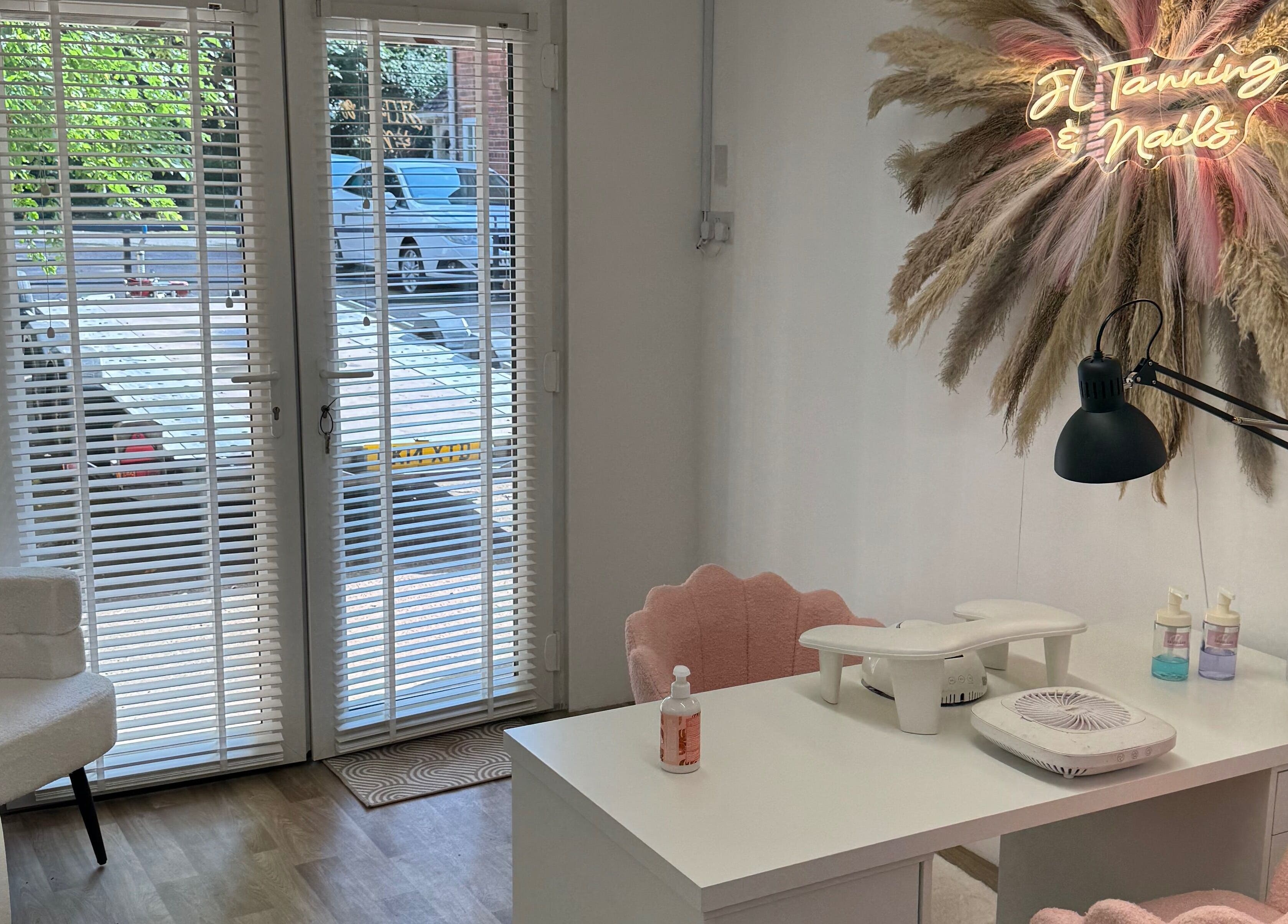 Nail station at JL Tanning and Nails, Exmouth, England, GB with stylish decor and neon sign.