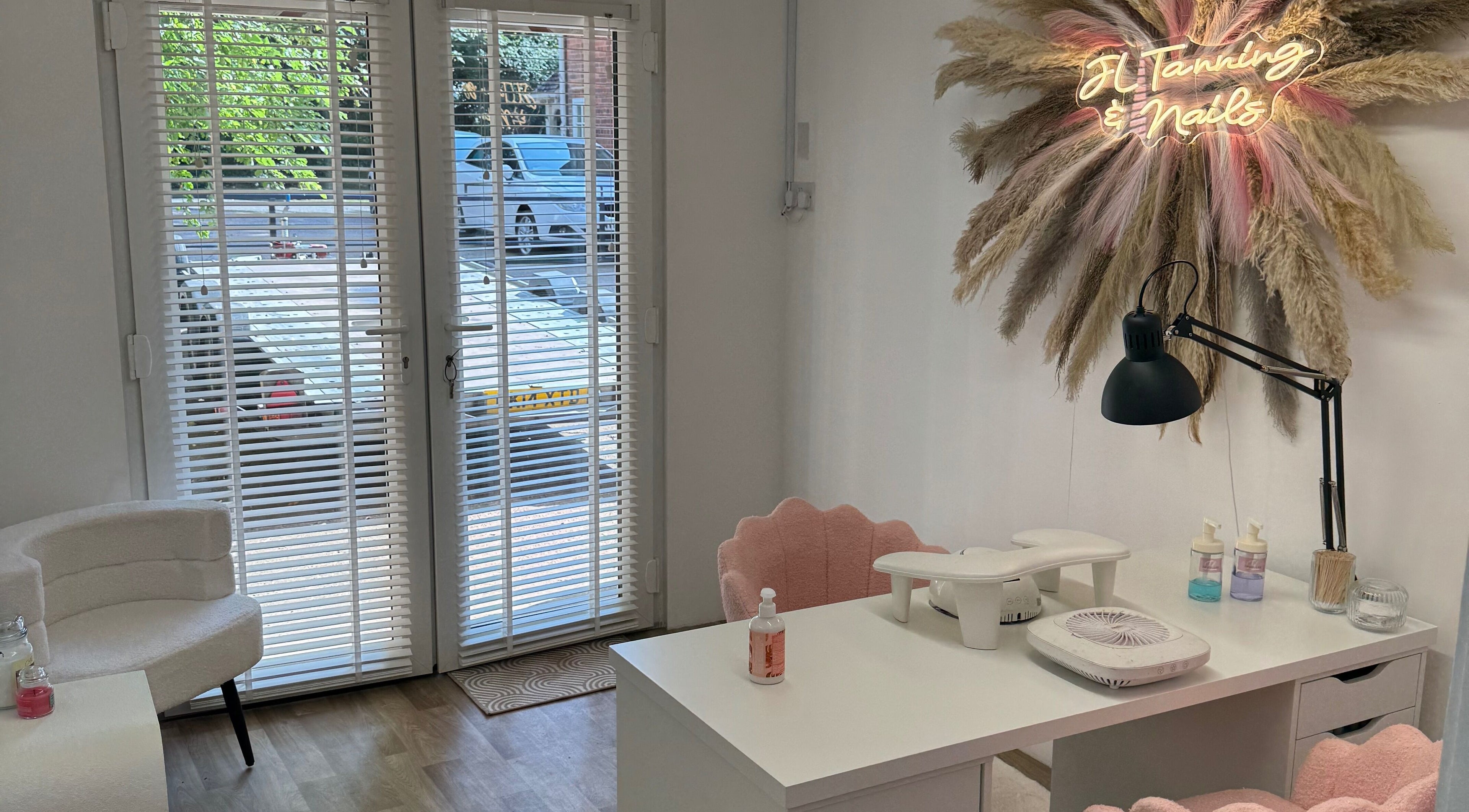 Nail station at JL Tanning and Nails, Exmouth, England, GB with stylish decor and neon sign.