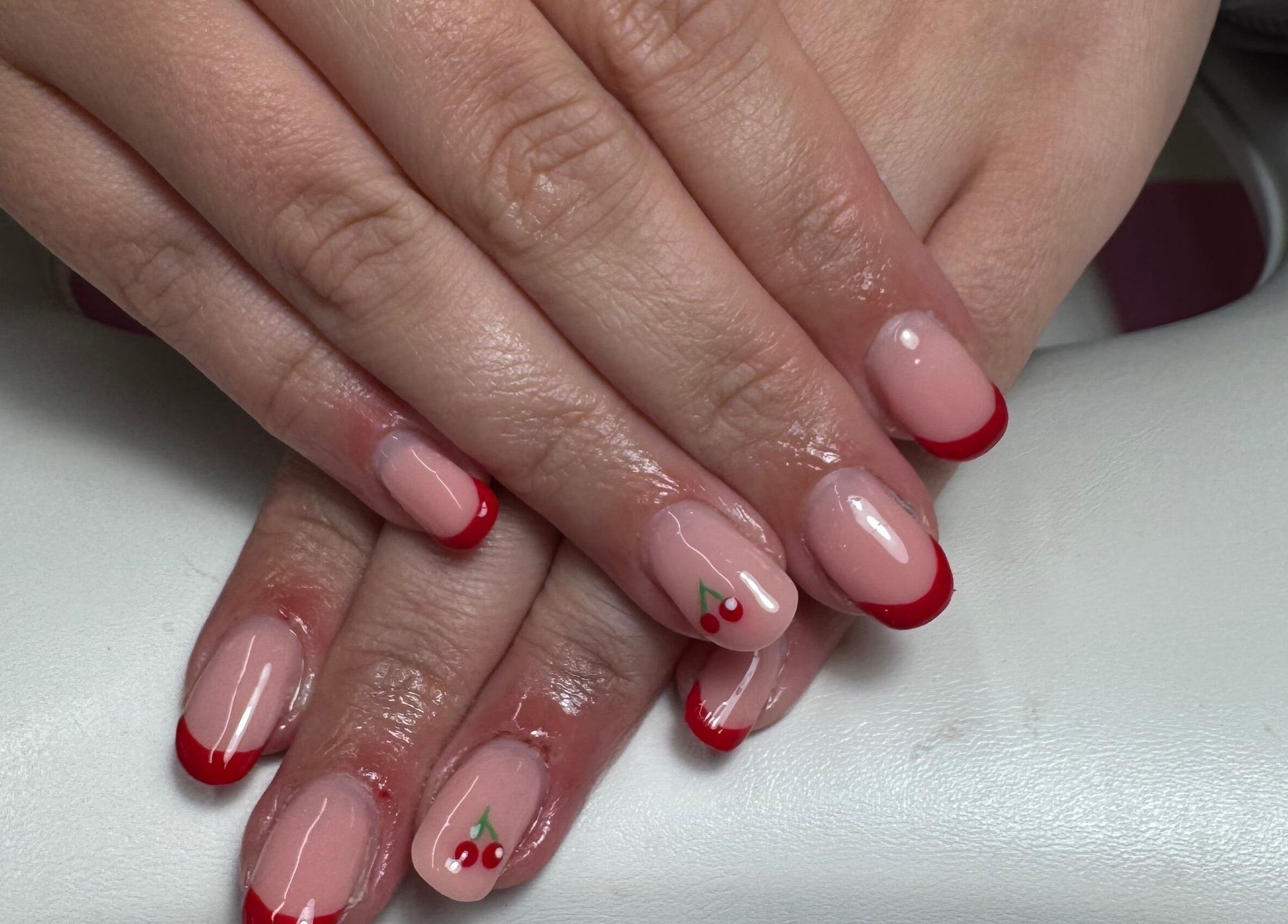 Stylish cherry nail art at JL Tanning and Nails, Exmouth, England, GB. Perfect manicure with red accents.